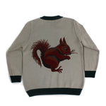 Back view of neutral knit sweater featuring a detailed squirrel motif