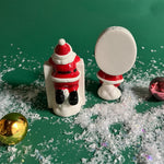 Two ceramic christmas salt and pepper shakers shaped like the letters 'H' and 'O' with Santa Claus figures on a white background.