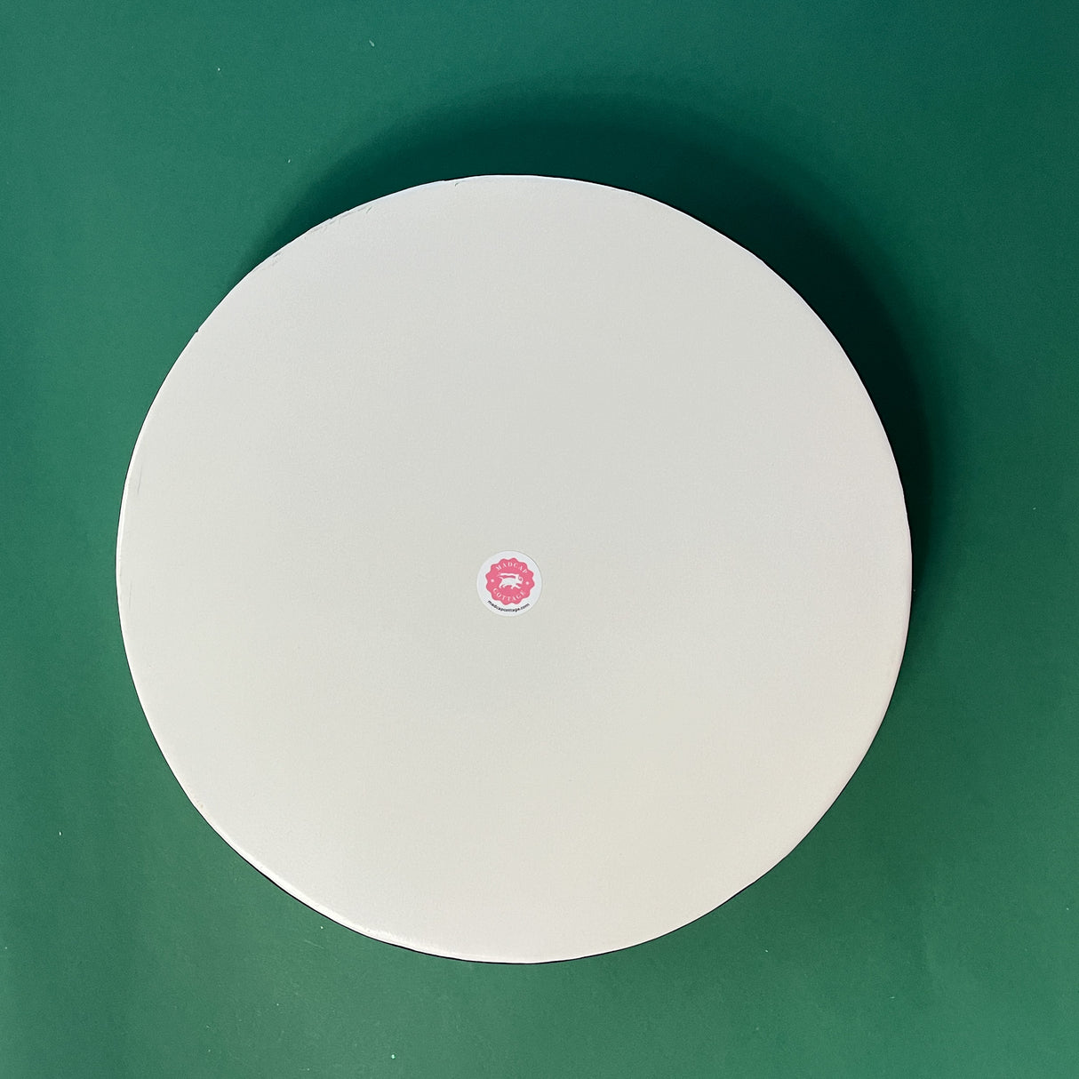 reverse side of a pink and green metal tole pug tray