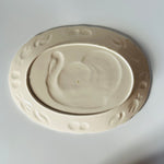 the plain white reverse side of a vintage turkey platter