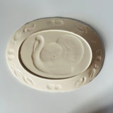 the plain white reverse side of a vintage turkey platter