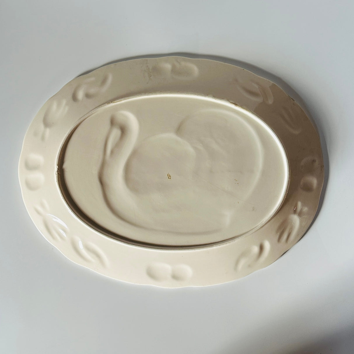 the plain white reverse side of a vintage turkey platter