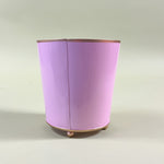 reverse side of a pink tole cachepot.