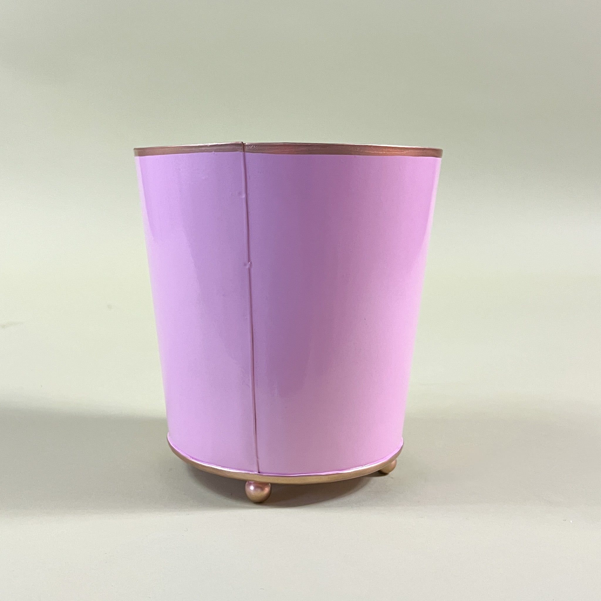 reverse side of a pink tole cachepot.