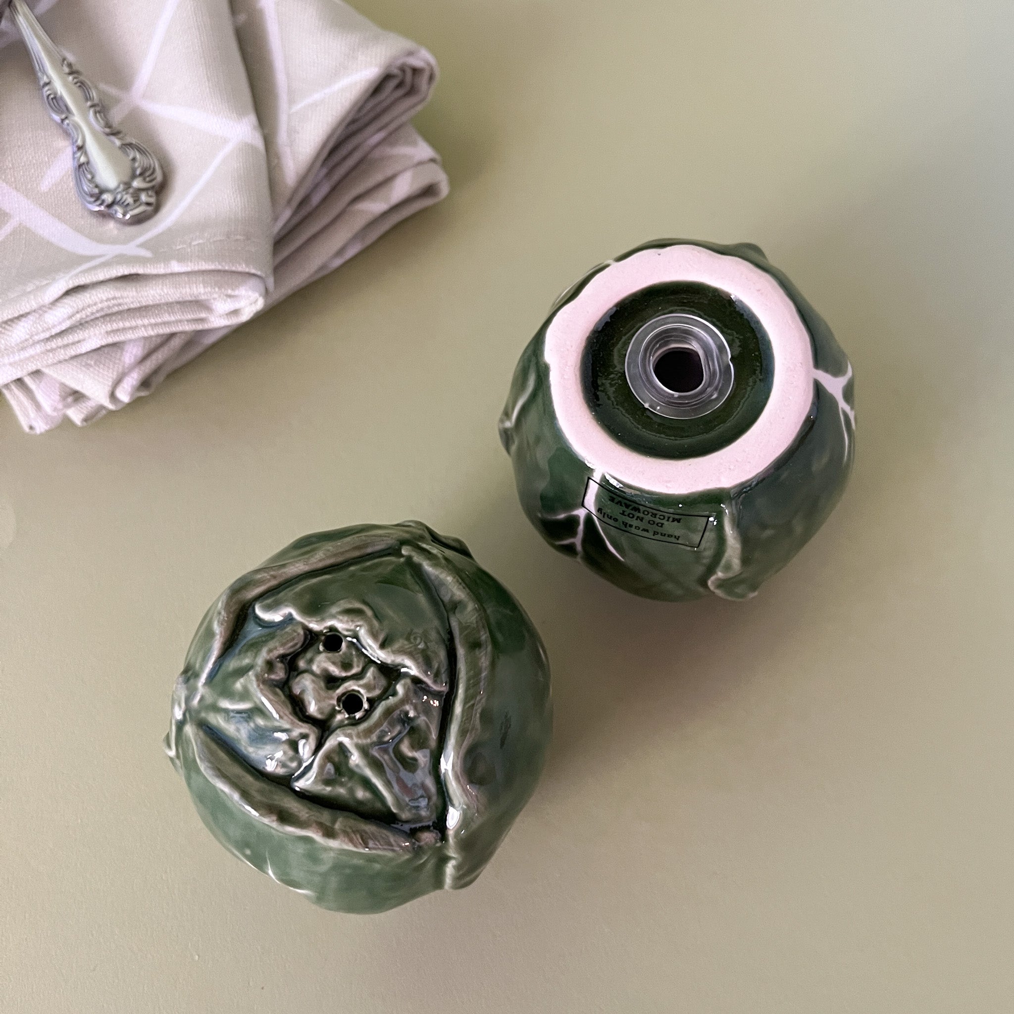 a pair of ceramic cabbage salt and pepper shakers.