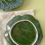 reverse side of a green ceramic cabbage leaf plate