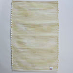 reverse side of a rectangular yellow accent rug with small daisy shaped accents scattered across it. 