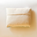 reverse side of a derby day pillow featuring a horse and jockey