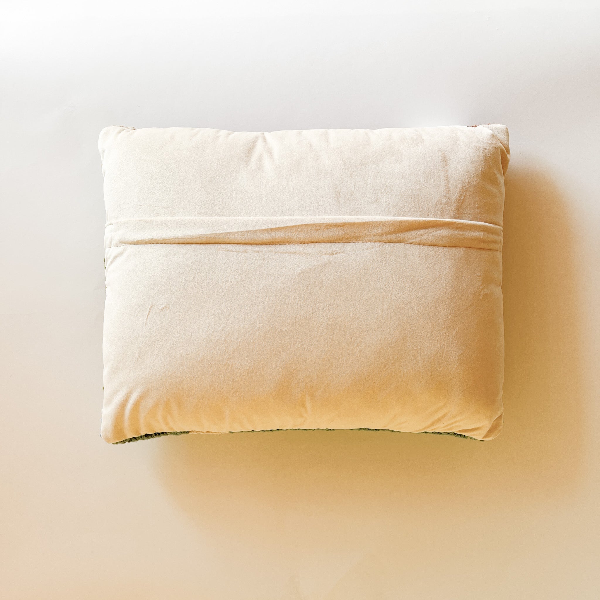 reverse side of a derby day pillow featuring a horse and jockey