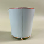 reverse side of a green tole cachepot