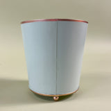 reverse side of a green tole cachepot
