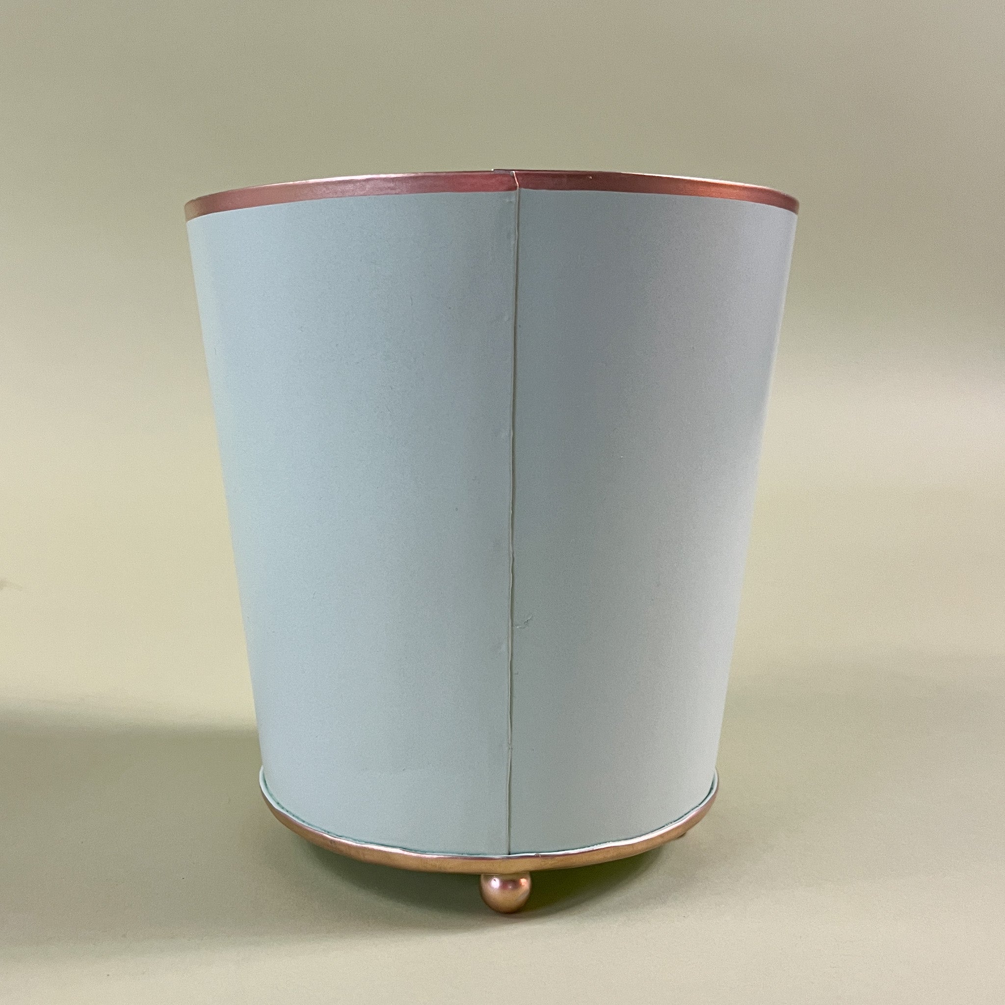 reverse side of a green tole cachepot