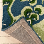 the reverse side of a blue and green rug with chinoiserie boatmen and pagoda motifs from madcap cottage.