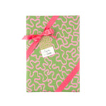 Playful gift wrap featuring whimsical pink ribbon patterns on a vibrant green background for gifting.