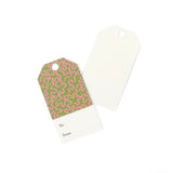 Pink and green Christmas gift tag featuring a playful swirling ribbon pattern, pre-punched hole, and printed To and From fields for personalized holiday gifting.
