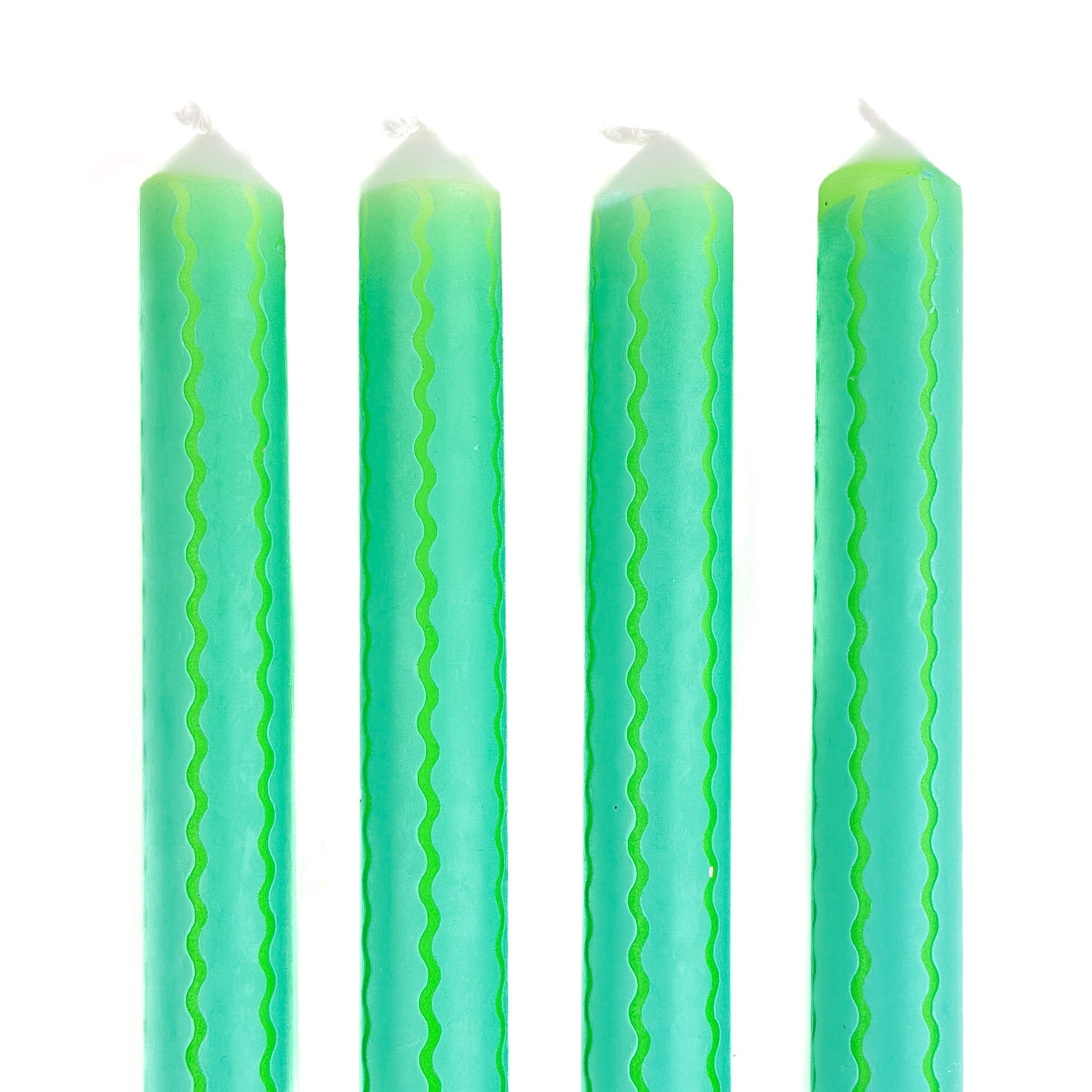 Green and blue ricrac stripe taper candles set with decorative wavy pattern for spring table decor.