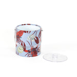 Rock Lobster red and blue ice bucket filled with ice and champagne features a green shell and red lobster print