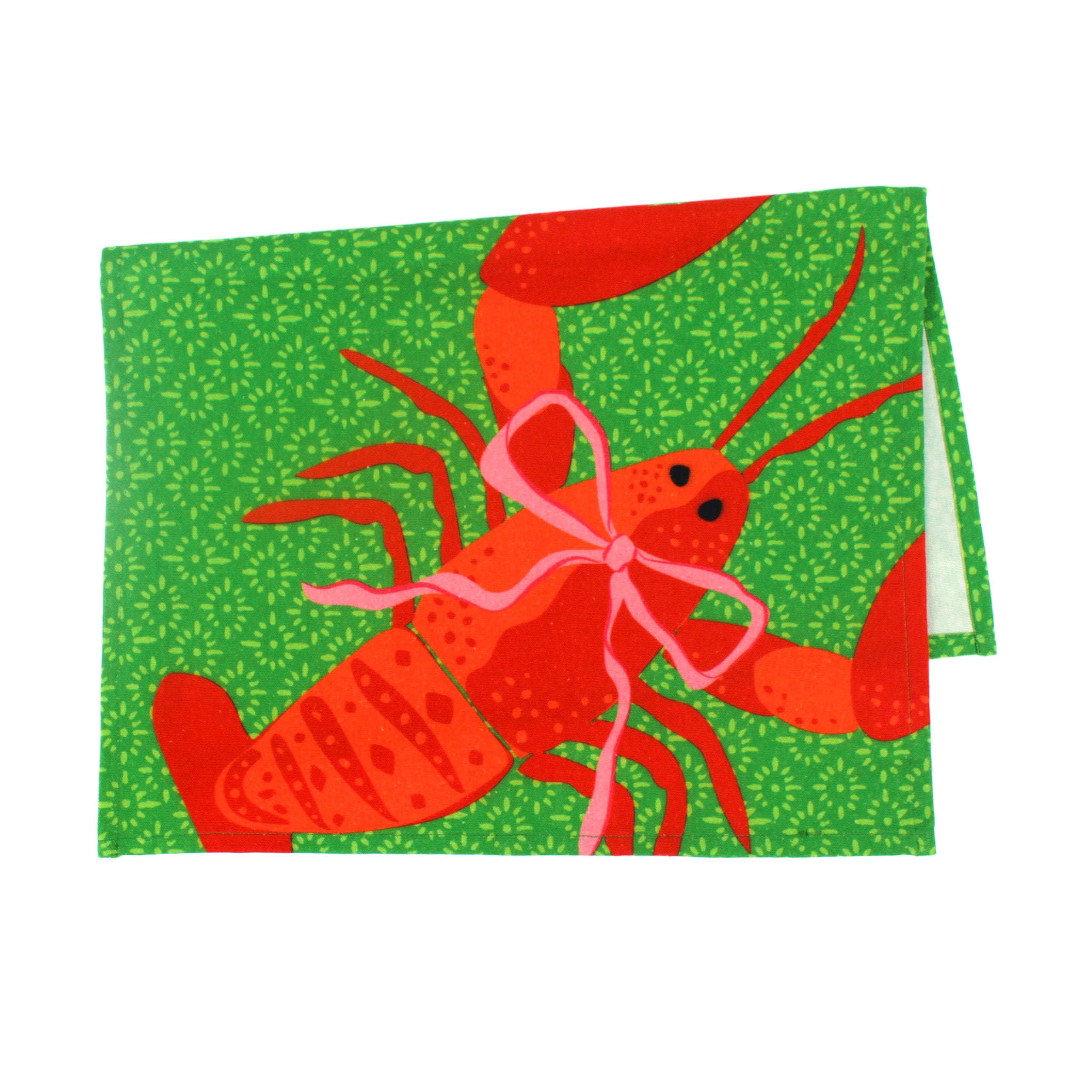 a green block print design and a big red lobster tea towel against a white background. 