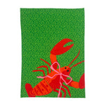 a green block print design and a big red lobster tea towel against a white background. 
