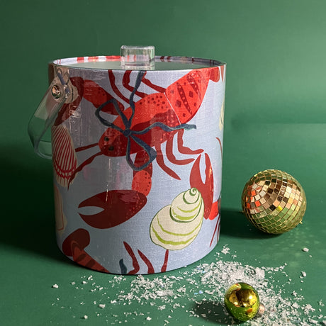 Light blue acrylic ice bucket covered in a red lobster and shell pattern. 