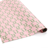 Roll of Bamboozled green and pink wrapping paper on a white background.
