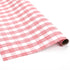 Roll of pink and white gingham wrapping paper with hand-drawn brushstroke pattern.