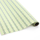 Light green Christmas wrapping paper roll with red and green holly-inspired stripe pattern, partially unrolled on a white surface.