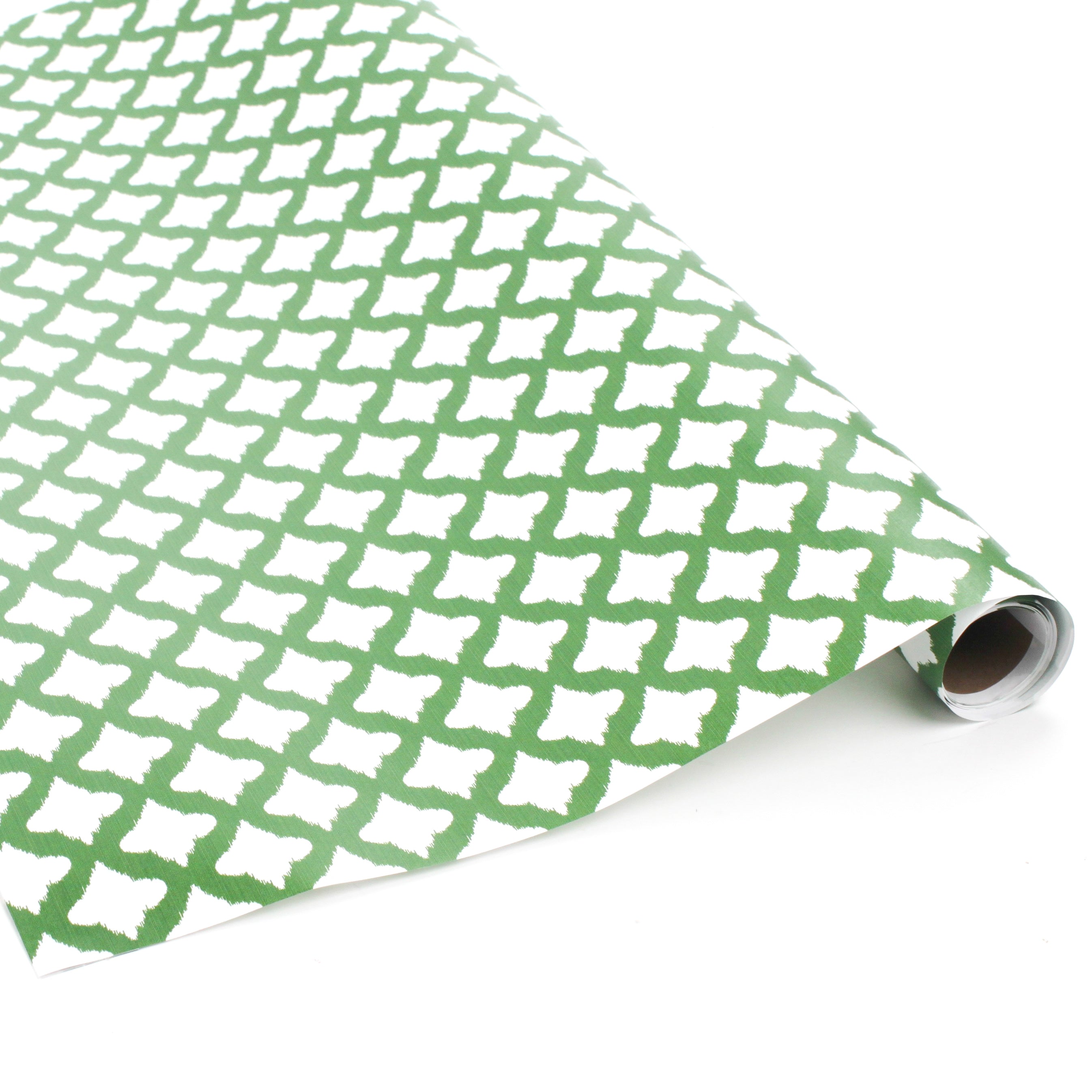 Roll of green wrapping paper with white abstract pattern on a white background.