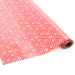 Rolled red gift wrap featuring white geometric square pattern.