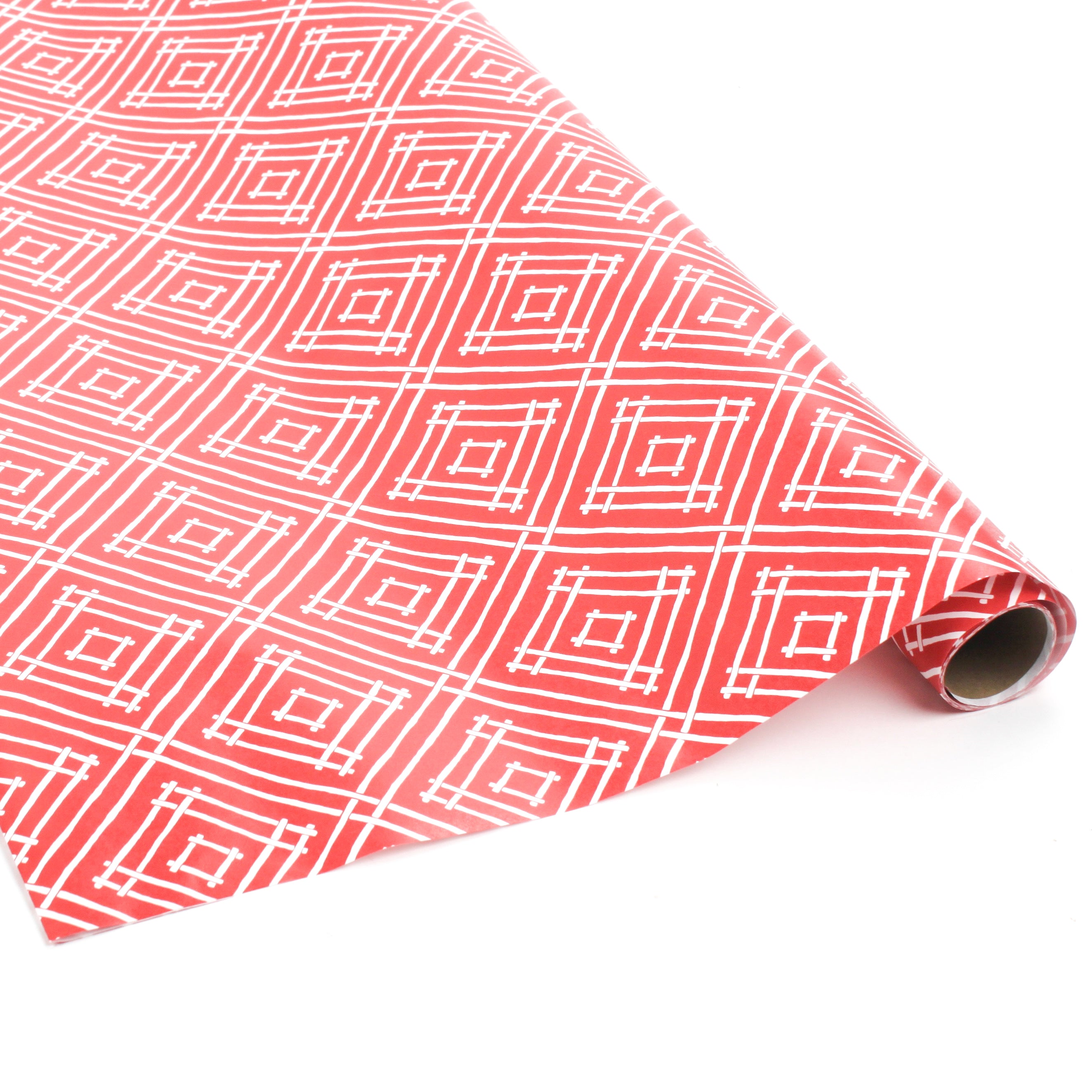 Rolled red gift wrap featuring white geometric square pattern.