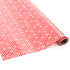 Rolled red gift wrap featuring white geometric square pattern.