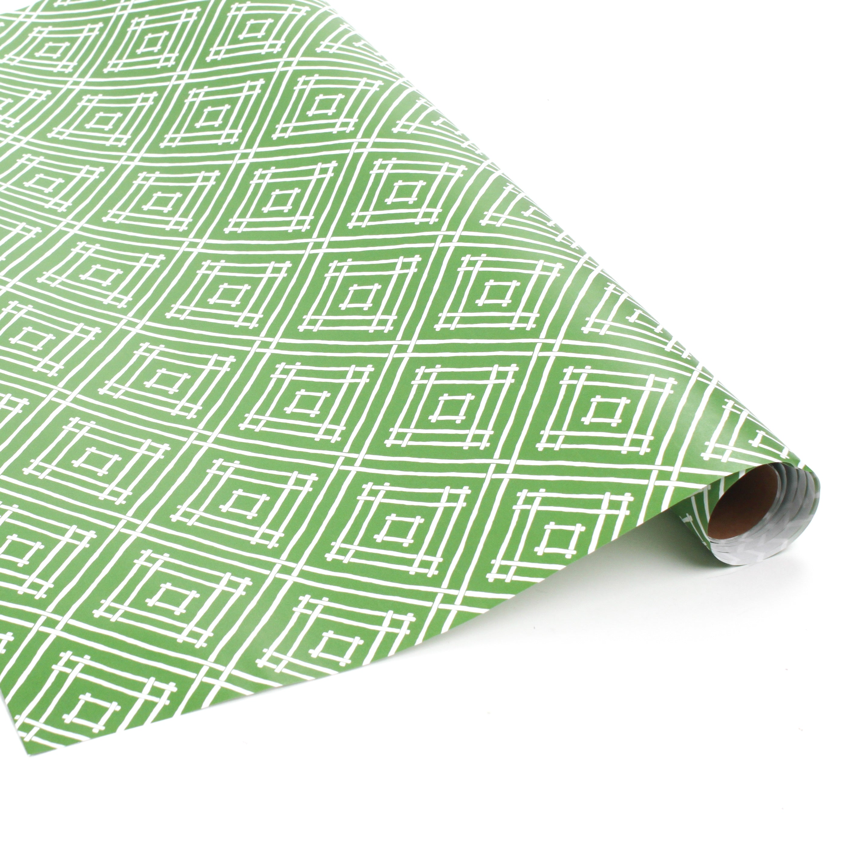 Rolls of wrapping paper with a geometric lattice pattern in green