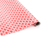 Roll of red wrapping paper with white geometric Monserrat pattern.