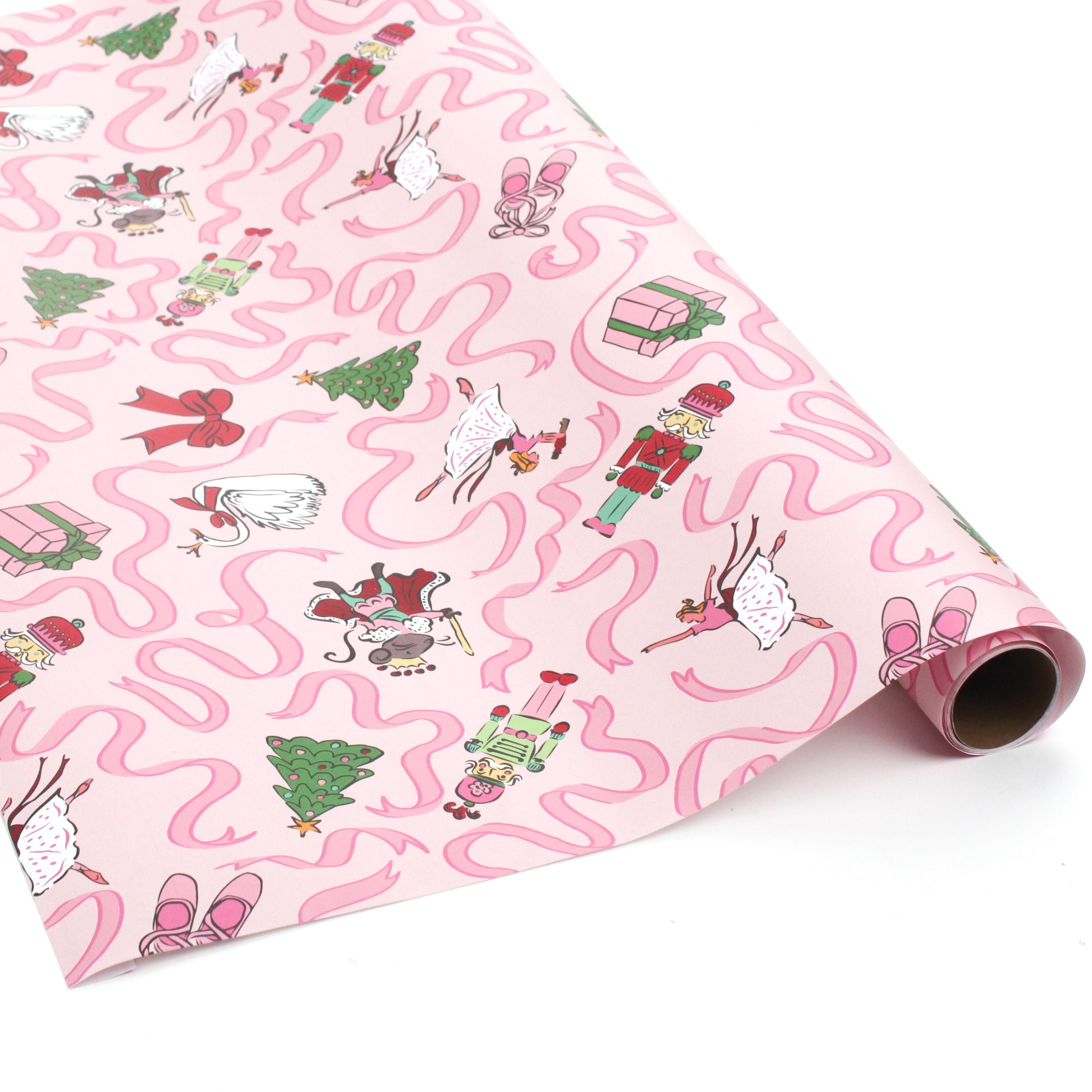 Roll of pink nutcracker Christmas wrapping paper featuring playful holiday characters and pink ribbon accents.
