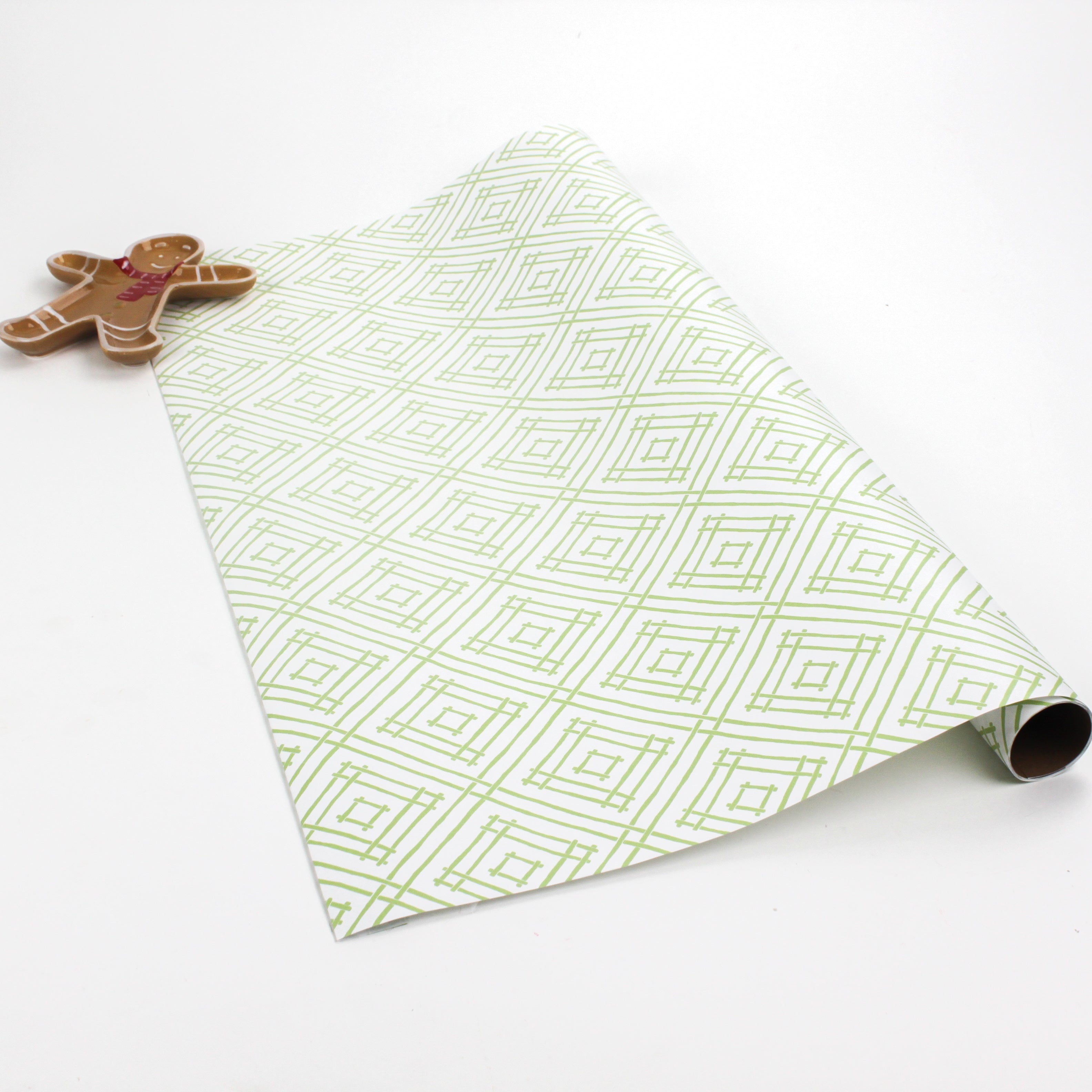 roll of a wrapping paper with a geometric lattice pattern in green