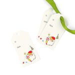 Two cream-colored gift tags with hanging holes, one printed with a cute cartoon Santa Claus and the other blank, shown on a white background.
