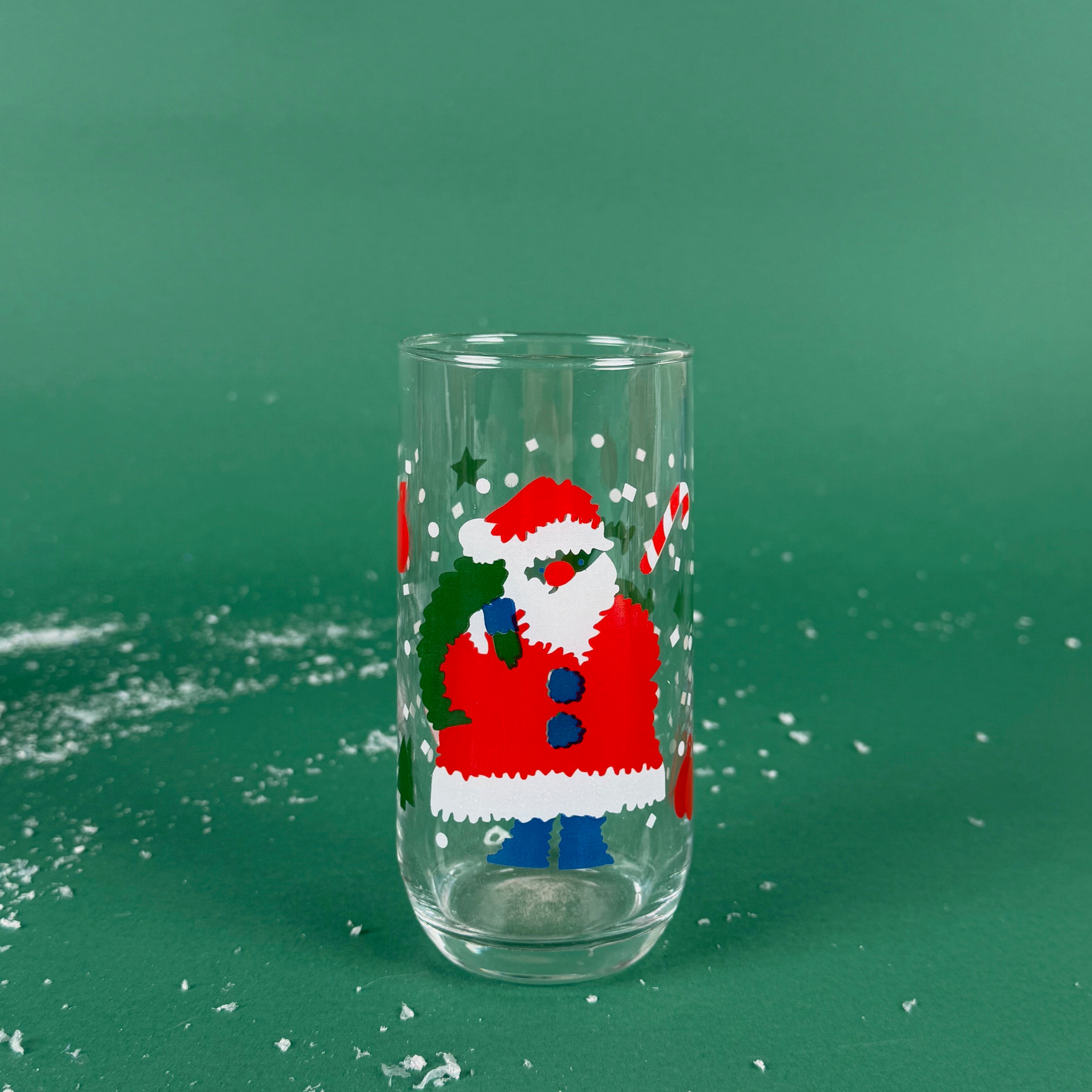 Clear drinking glass with a festive Santa Claus design