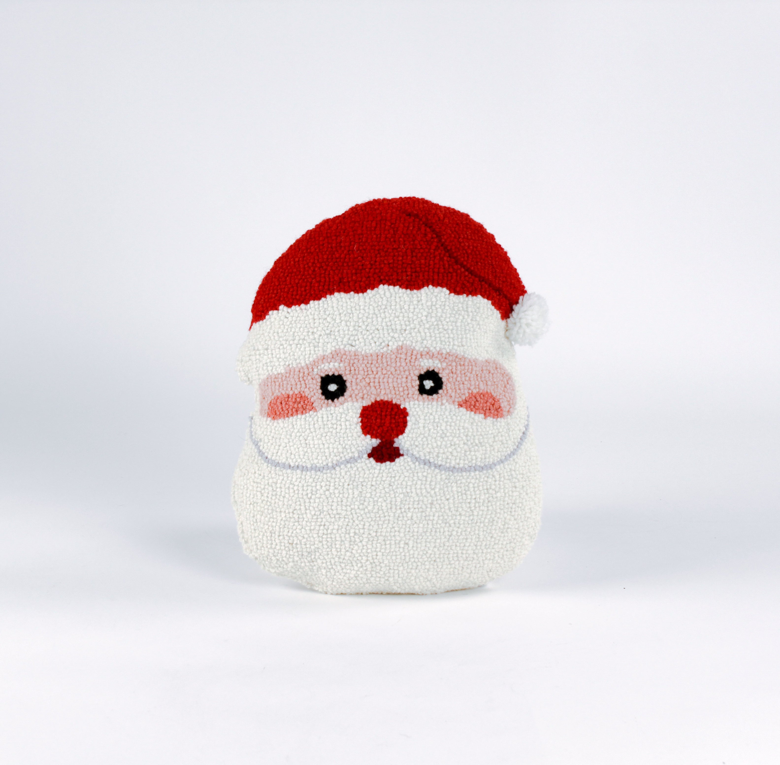 Santa-shaped hooked wool christmas pillow with a hooked texture, featuring Santa’s face with rosy cheeks, a red nose, and a bright red hat with a white pom-pom.