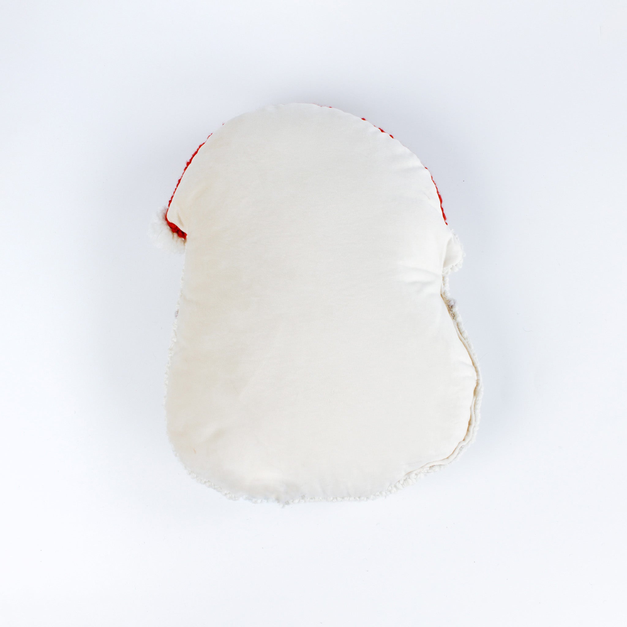 reverse back of a Santa-shaped decorative pillow with a hooked texture, featuring Santa’s face with rosy cheeks, a red nose, and a bright red hat with a white pom-pom.