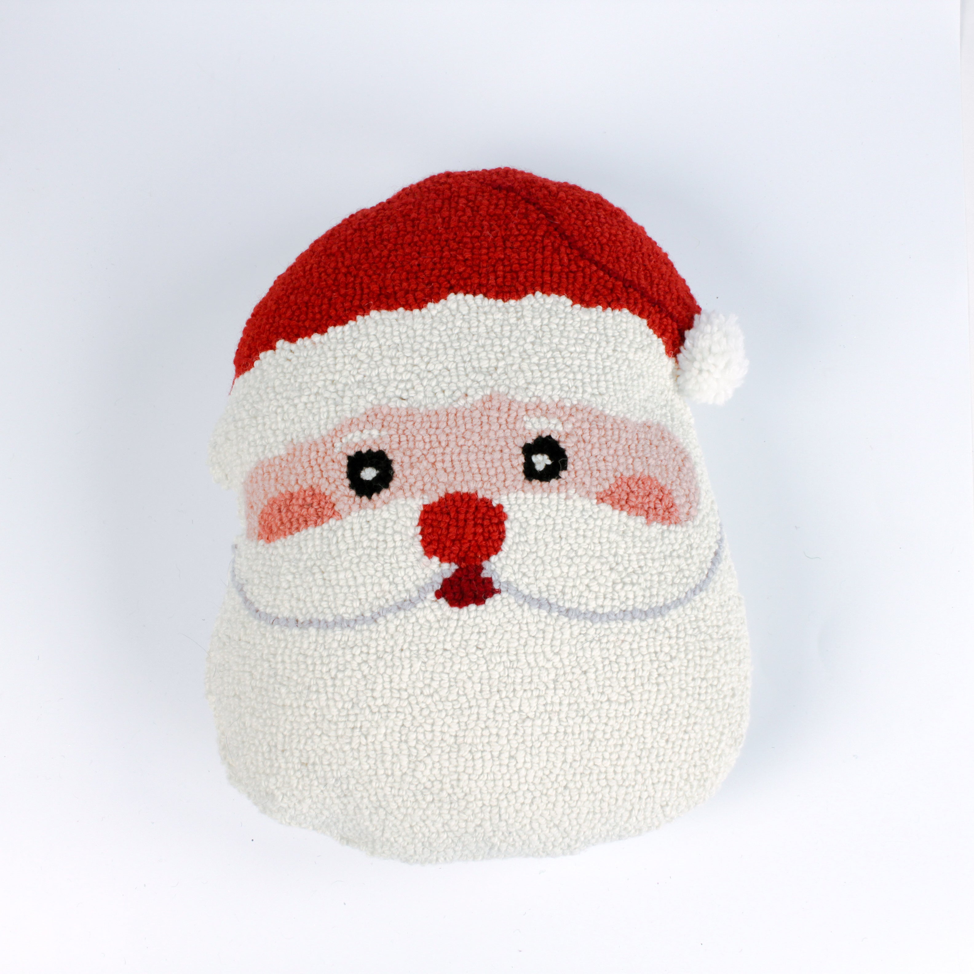 Santa-shaped christmas pillow with a hooked texture, featuring Santa’s face with rosy cheeks, a red nose, and a bright red hat with a white pom-pom.