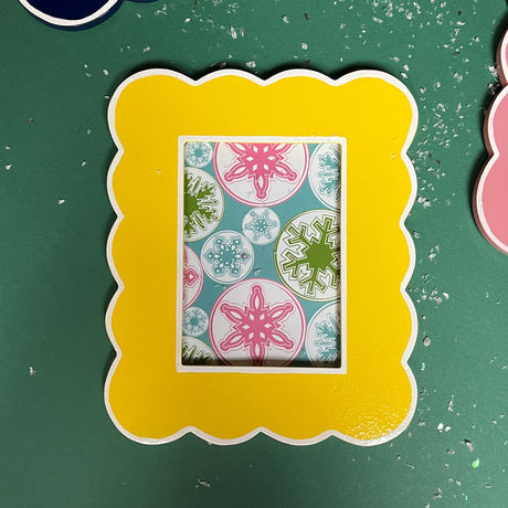 a scalloped edge yellow photo frame