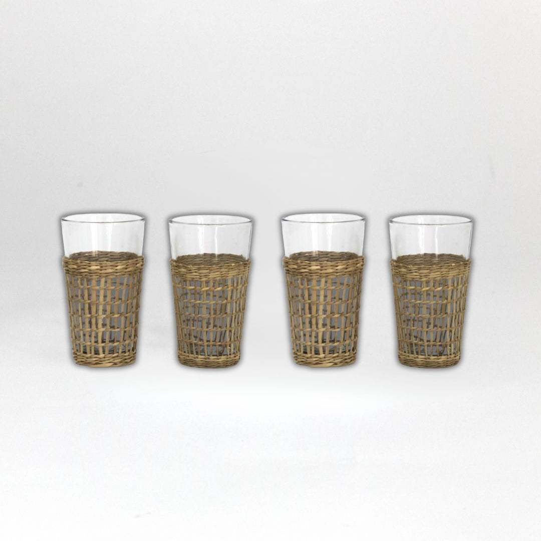 Four glasses with wicker sleeves on a white background