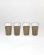 Four glasses with wicker sleeves on a white background