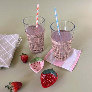 drinking glasses with seagrass sleeve with strawberry accent plates