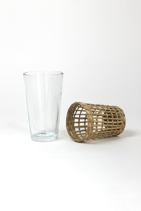 seagrass wrapped glasses from madcap cottage with the seagrass wrapping on the side to the right of a plain glass. 