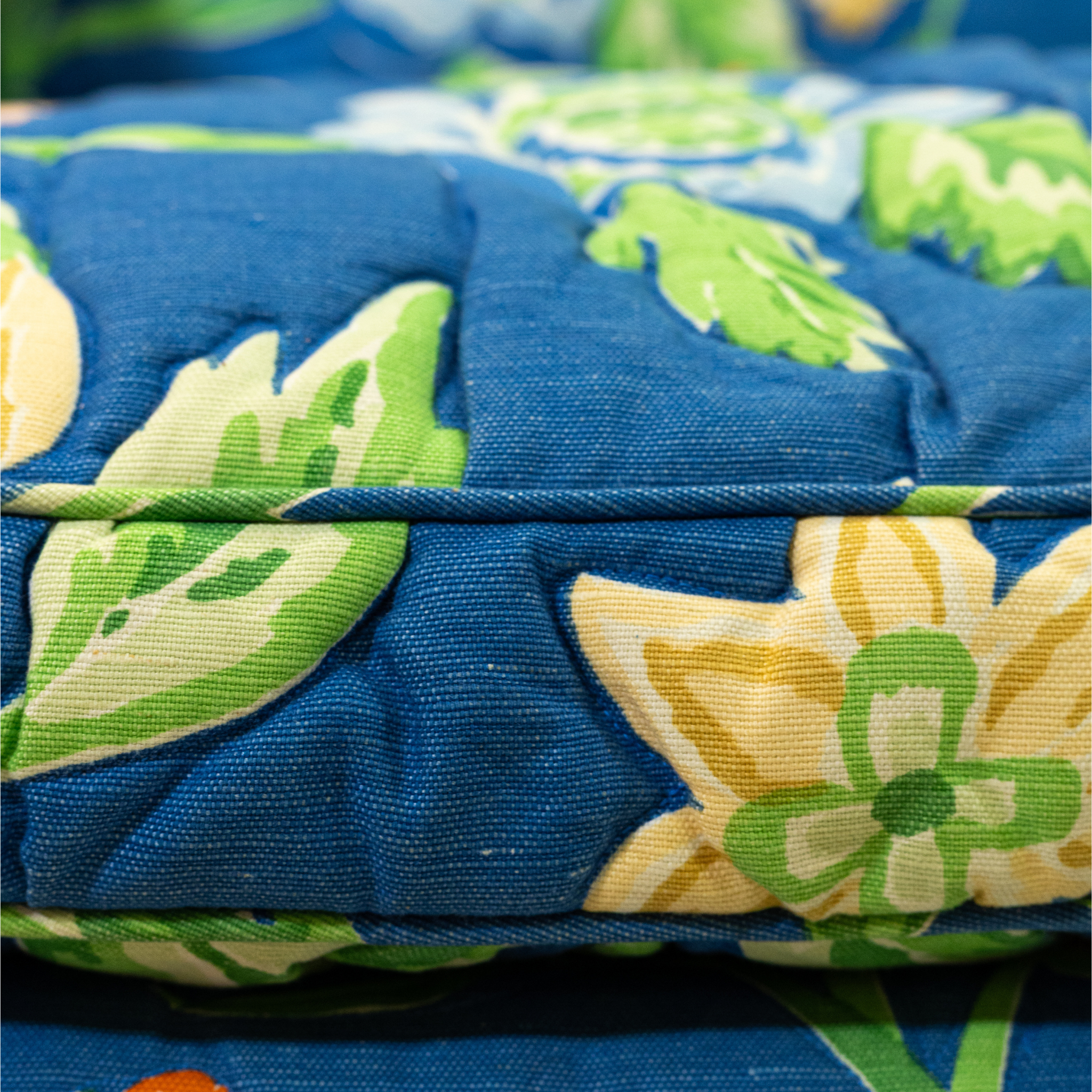 Seat detail of Blue floral upholstered loveseat with botanical pattern and rolled arms