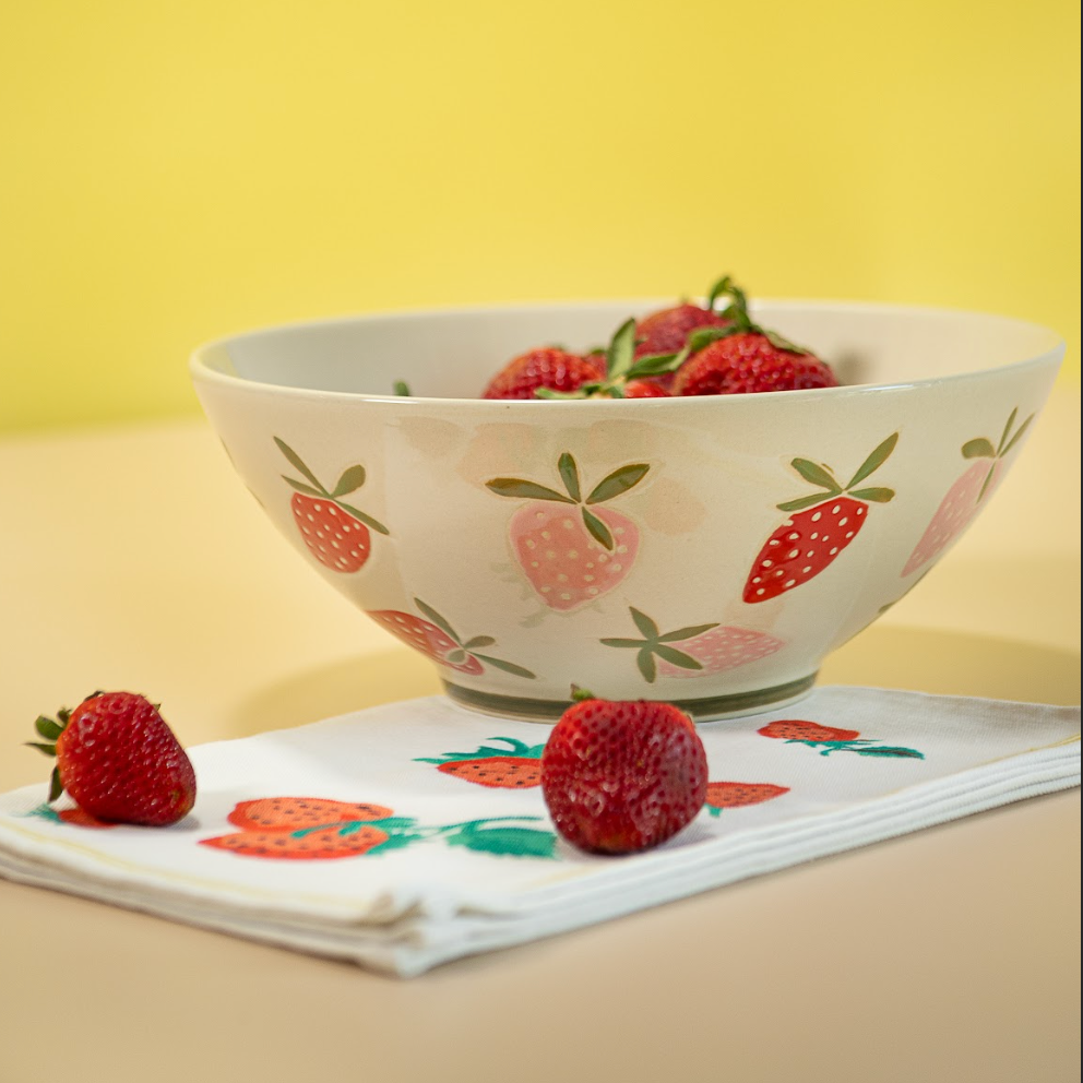 A large strawberry serving bowl with white and pink strawberry motifs decorating the exterior