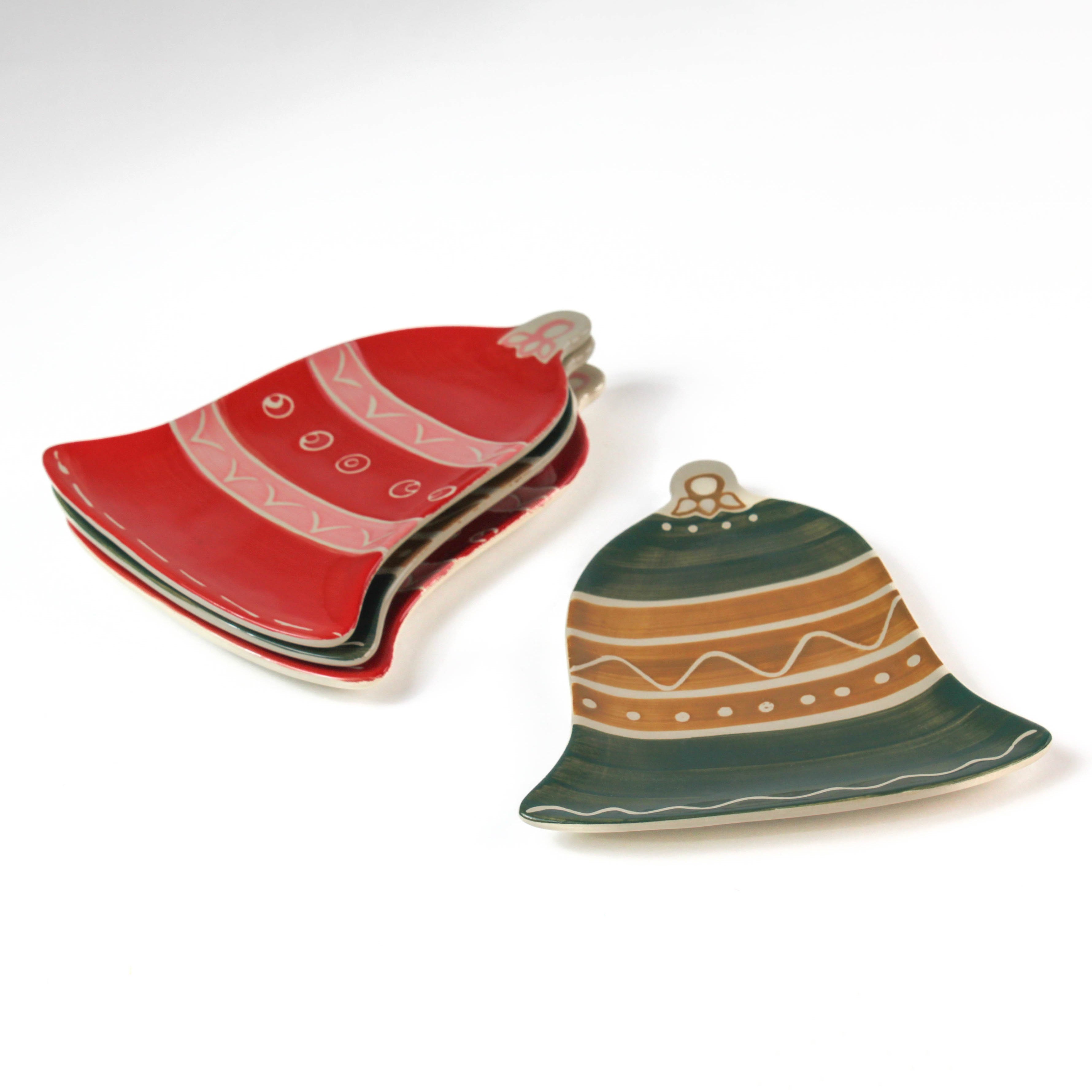 Set of ceramic bell-shaped christmas plates on a white background