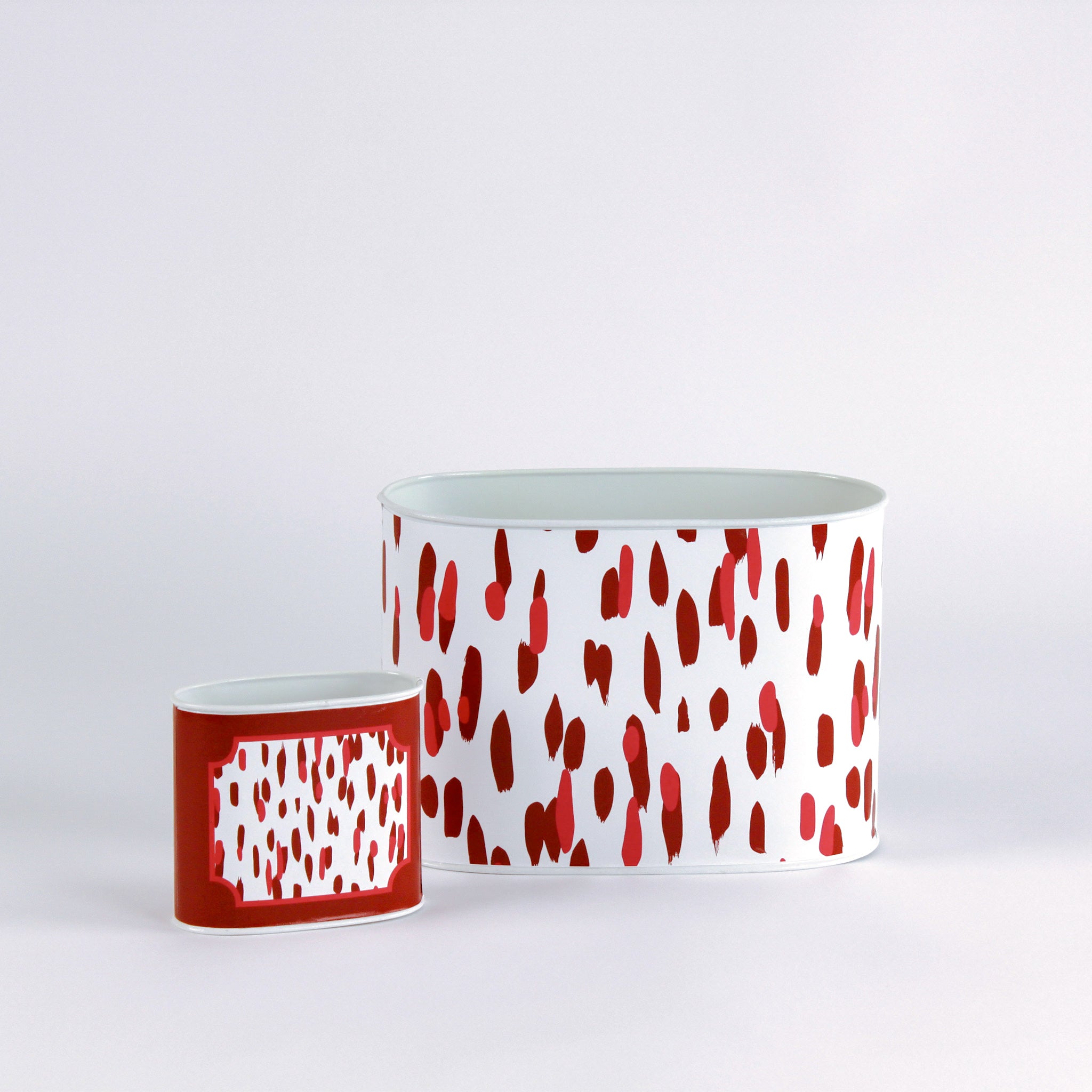 madcap Cottage caddies with red abstract patterns on a white background