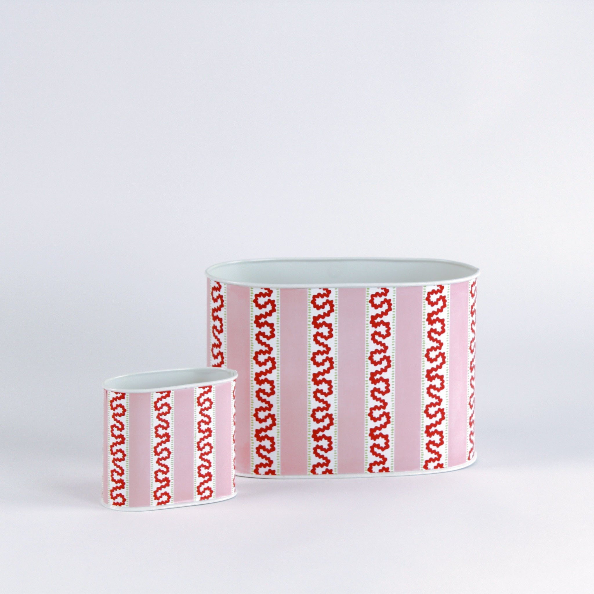 2 Madcap Cottage Caddies with pink and red geometric patterns on a white background